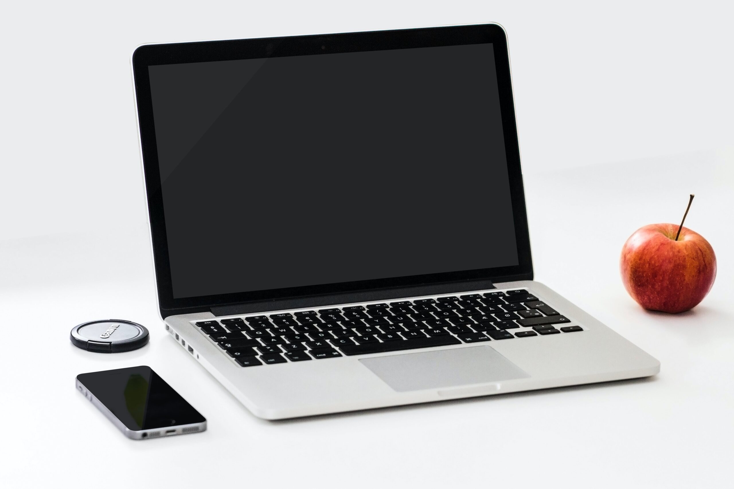 Macbook pro near iphone and apple fruit